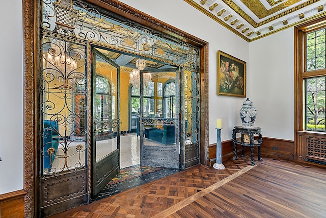 1771 Balmoral Dr, Detroit, MI 48203 - foyer featuring crown molding, parquet flooring, and a wainscoted wall