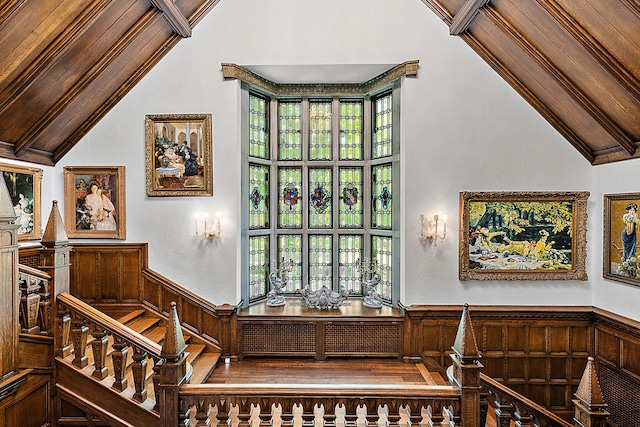 1771 Balmoral Dr, Detroit, MI 48203 - staircase with wainscoting, crown molding, wood walls, and vaulted ceiling