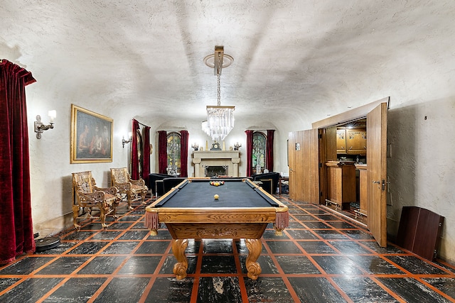 1771 Balmoral Dr, Detroit, MI 48203 - recreation room featuring a fireplace, billiards, a textured wall, and a chandelier