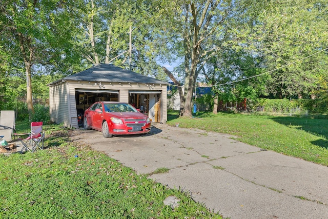 detached garage featuring fence