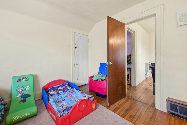 bedroom featuring visible vents and wood finished floors