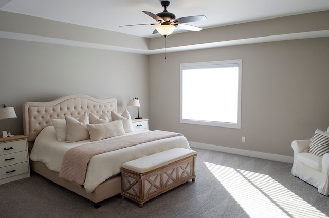 carpeted bedroom featuring a ceiling fan and baseboards