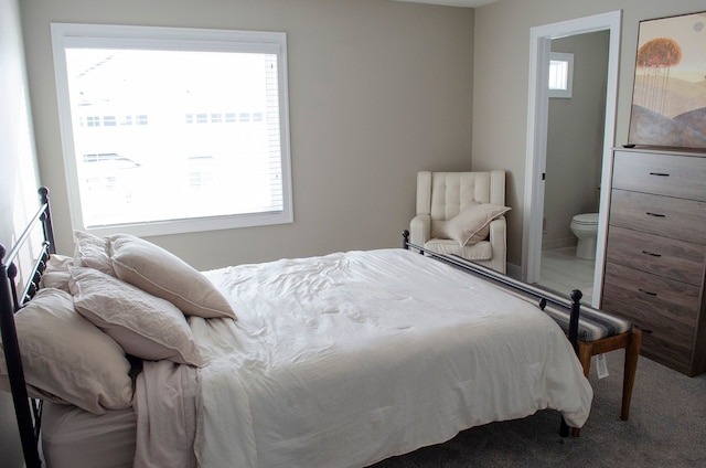 carpeted bedroom featuring ensuite bathroom