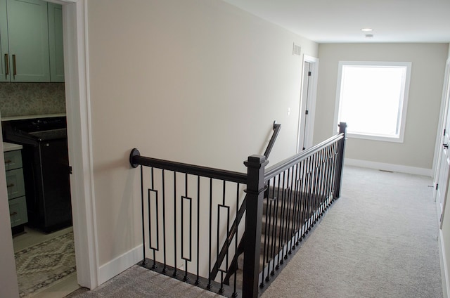 stairs featuring visible vents, baseboards, and carpet flooring