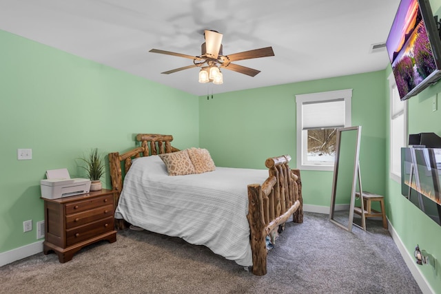 carpeted bedroom featuring visible vents, a ceiling fan, and baseboards