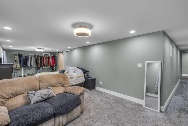 living room featuring carpet, recessed lighting, baseboards, and a barn door