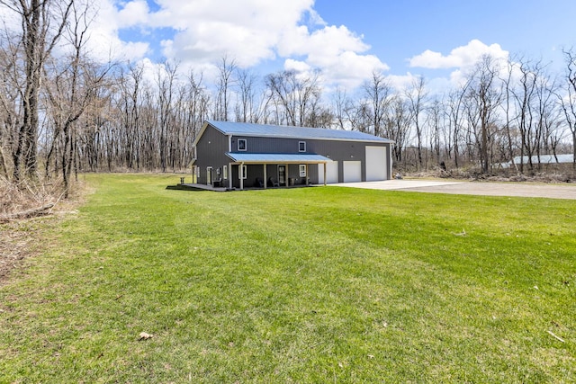 229 S Sutton Rd, Jackson, MI 49203 - view of front of property featuring driveway, a front lawn, and metal roof
