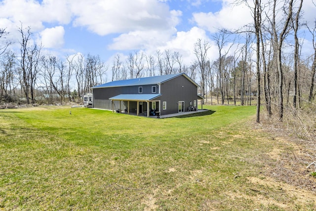 229 S Sutton Rd, Jackson, MI 49203 - back of house featuring a lawn and metal roof