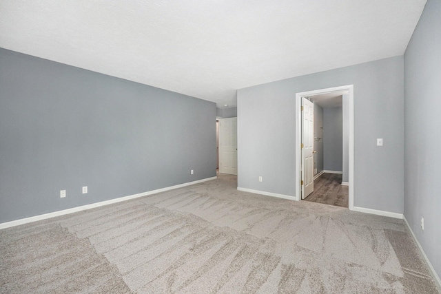 unfurnished bedroom with light carpet and baseboards