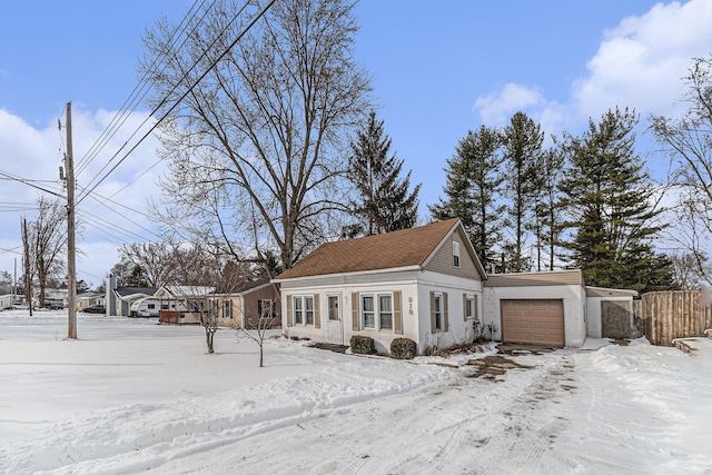 view of snow covered exterior featuring an attached garage