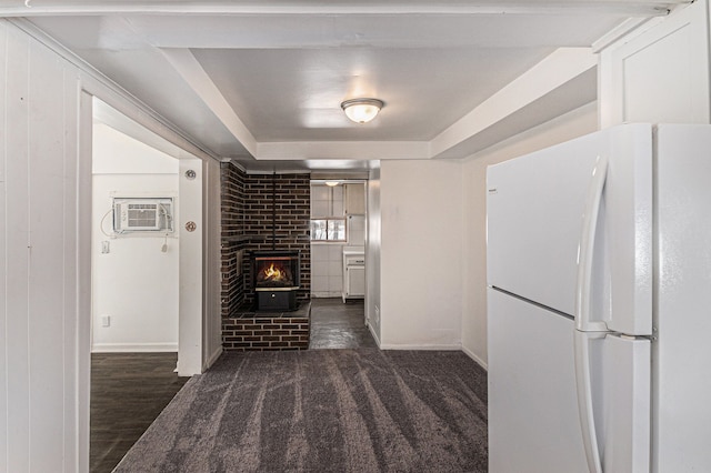 unfurnished living room with carpet, a fireplace, baseboards, and a wall mounted AC