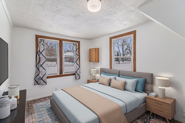 bedroom with baseboards, a textured ceiling, and ornamental molding