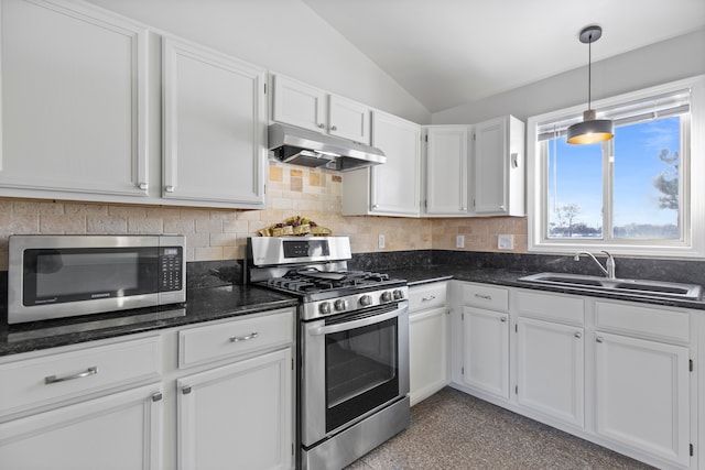 kitchen featuring lofted ceiling, stainless steel appliances, under cabinet range hood, white cabinetry, and a sink