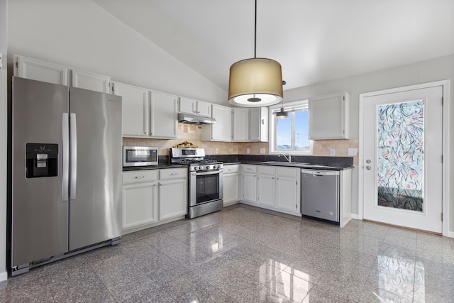 kitchen with appliances with stainless steel finishes, dark countertops, white cabinetry, and under cabinet range hood