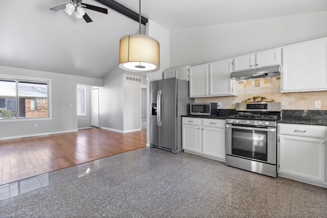 kitchen featuring baseboards, dark countertops, appliances with stainless steel finishes, under cabinet range hood, and white cabinetry