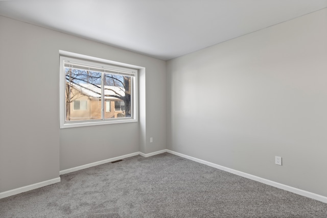 carpeted spare room with baseboards