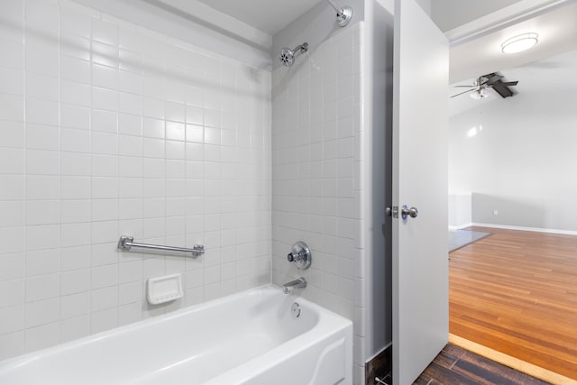 bathroom featuring  shower combination, baseboards, and wood finished floors