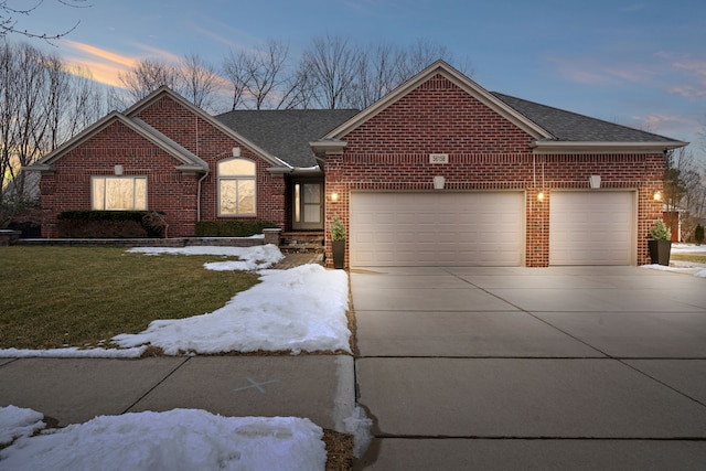 single story home with an attached garage, a lawn, concrete driveway, and brick siding