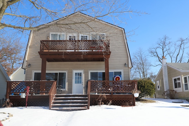 view of front of property with a balcony and a gambrel roof