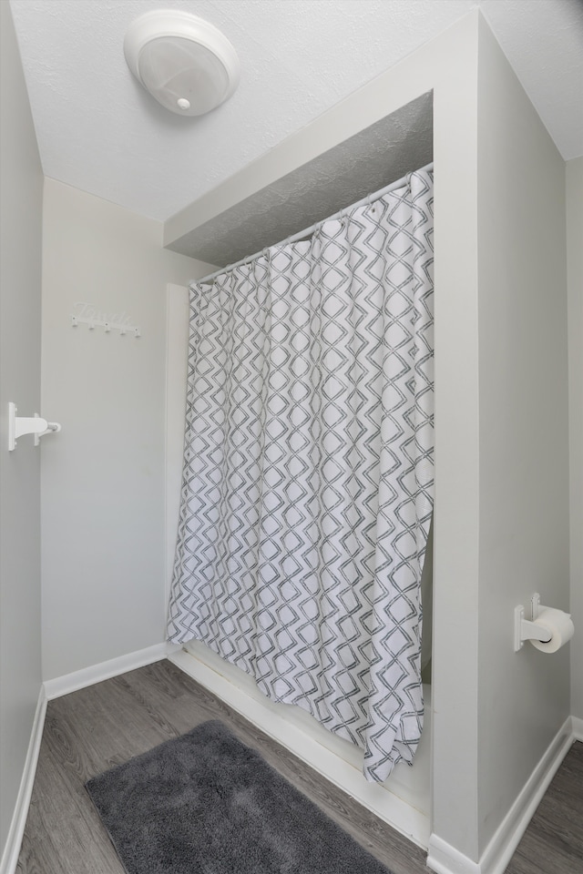 8860 Rushside Dr, Pinckney, MI 48169 - bathroom with wood finished floors and baseboards