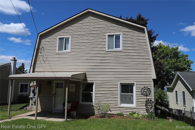 8860 Rushside Dr, Pinckney, MI 48169 - back of property featuring a patio area and a gambrel roof