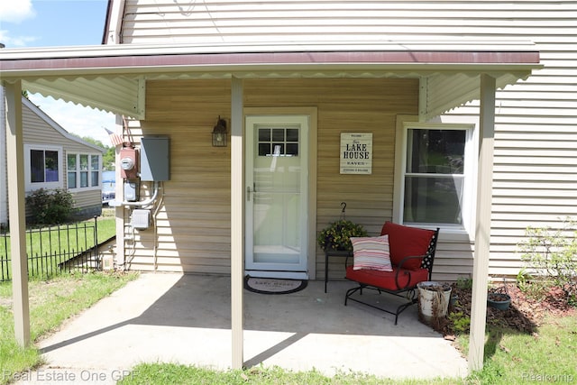 8860 Rushside Dr, Pinckney, MI 48169 - doorway to property featuring a porch