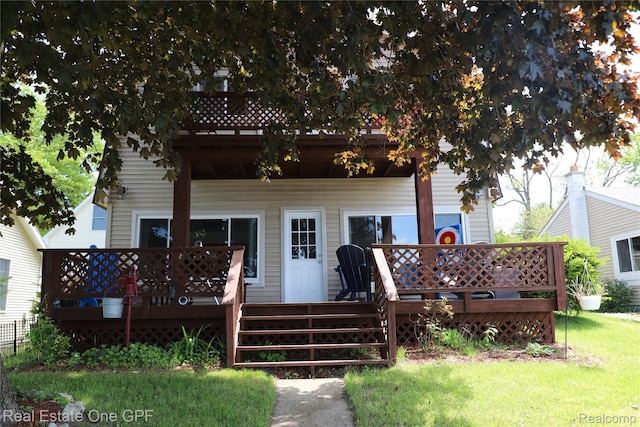 8860 Rushside Dr, Pinckney, MI 48169 - rear view of house featuring a deck and a yard