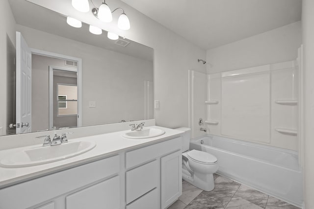 bathroom with shower / bath combination, a sink, visible vents, and toilet