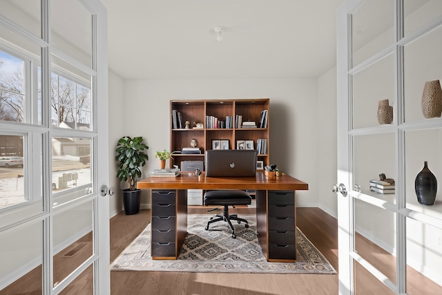 office space featuring baseboards and wood finished floors