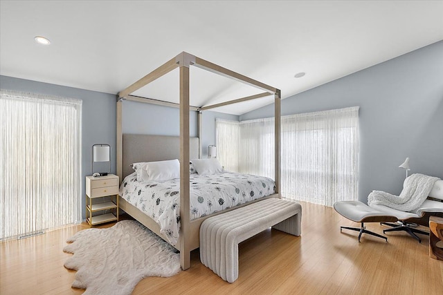 bedroom featuring vaulted ceiling, wood finished floors, and recessed lighting