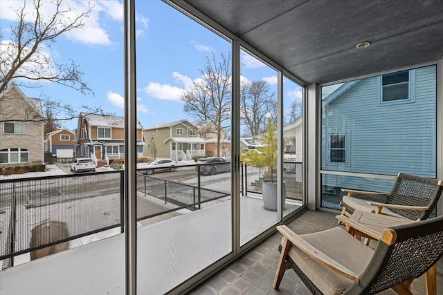 sunroom / solarium featuring a residential view