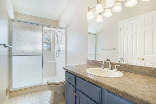 bathroom featuring toilet, a stall shower, vanity, and tile patterned floors