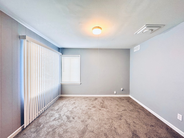 unfurnished room featuring carpet floors, baseboards, and visible vents