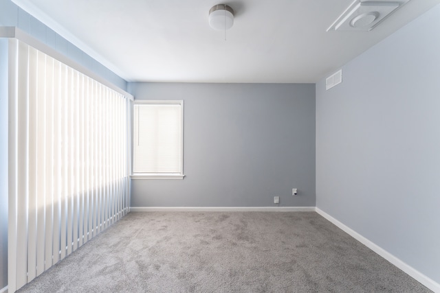 unfurnished room with light carpet, baseboards, and visible vents