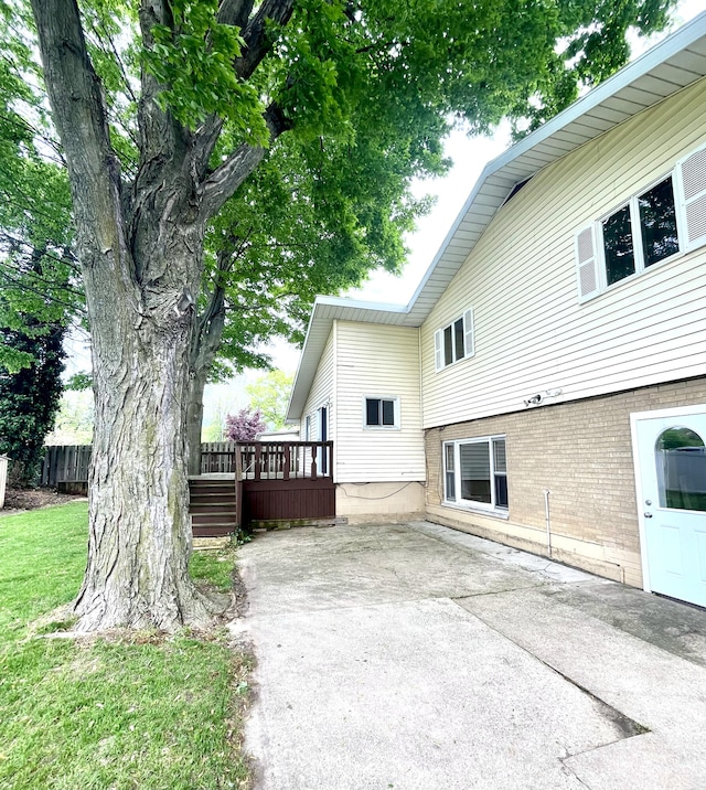 2264 Lynn Dr, Saint Joseph, MI 49085 - view of side of property with a patio, a wooden deck, and brick siding