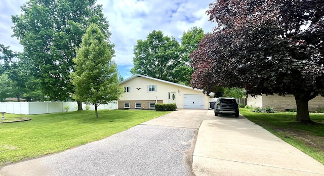 2264 Lynn Dr, Saint Joseph, MI 49085 - tri-level home featuring concrete driveway, brick siding, and a garage