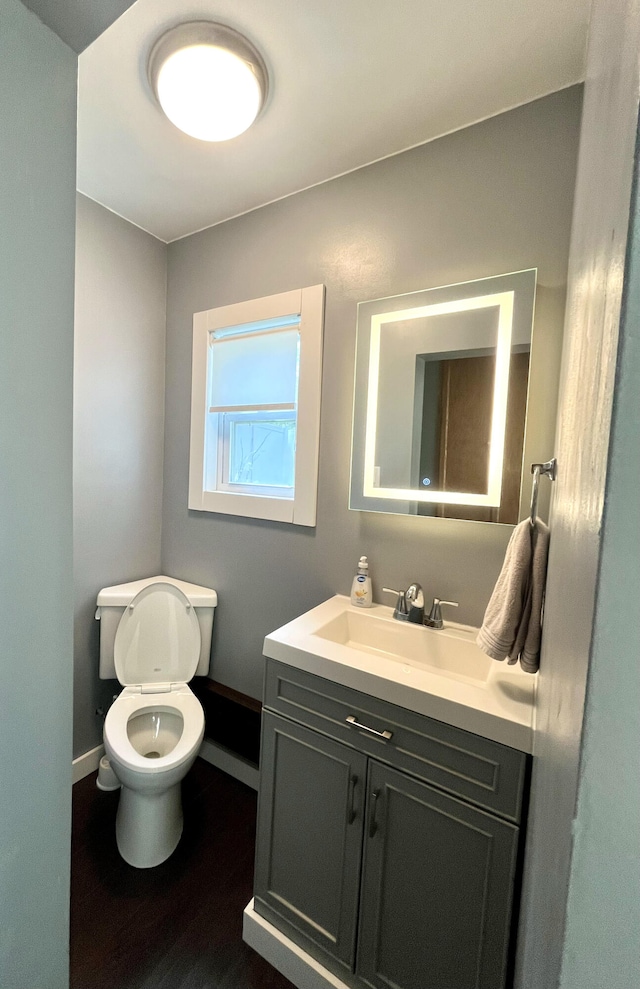 2264 Lynn Dr, Saint Joseph, MI 49085 - bathroom with vanity, baseboards, toilet, and wood finished floors