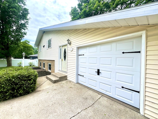 2264 Lynn Dr, Saint Joseph, MI 49085 - view of property exterior with entry steps, driveway, and a garage