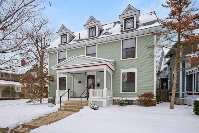 american foursquare style home with covered porch