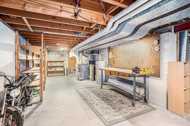 unfinished basement with a workshop area and gas water heater