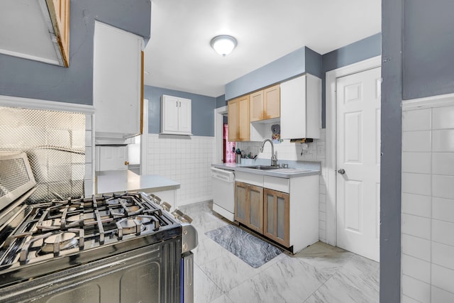 kitchen with white cabinets, light countertops, white dishwasher, and marble finish floor