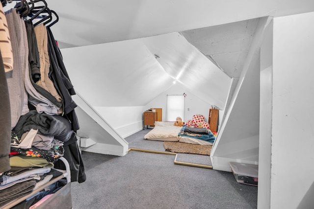 bedroom featuring lofted ceiling, carpet flooring, and baseboards