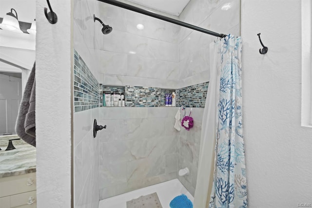 full bath featuring a textured wall and a shower stall