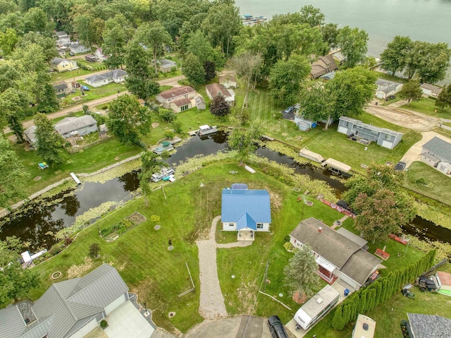 drone / aerial view with a water view and a residential view