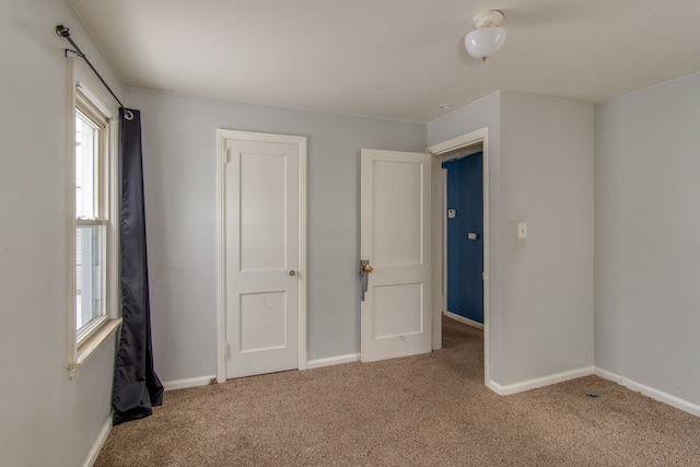 unfurnished bedroom featuring baseboards and carpet floors