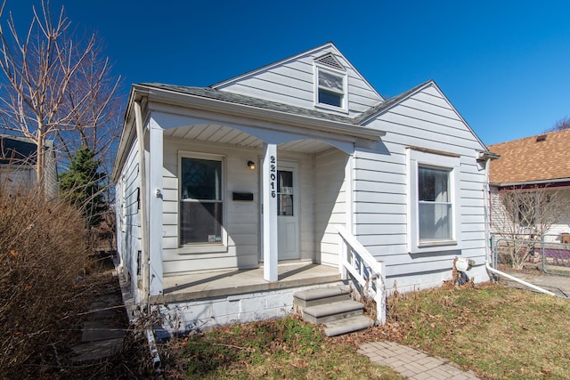 bungalow with roof with shingles and covered porch