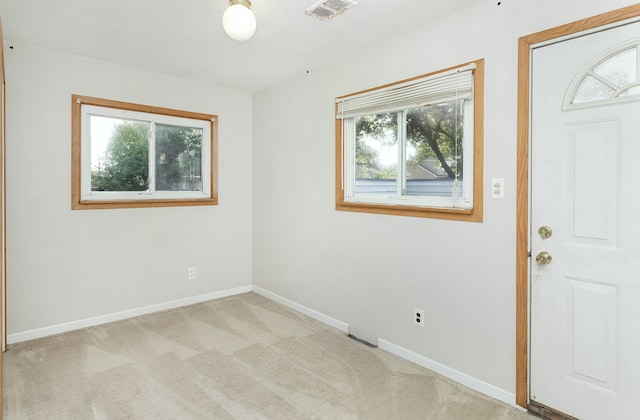 unfurnished room featuring light carpet, baseboards, and visible vents