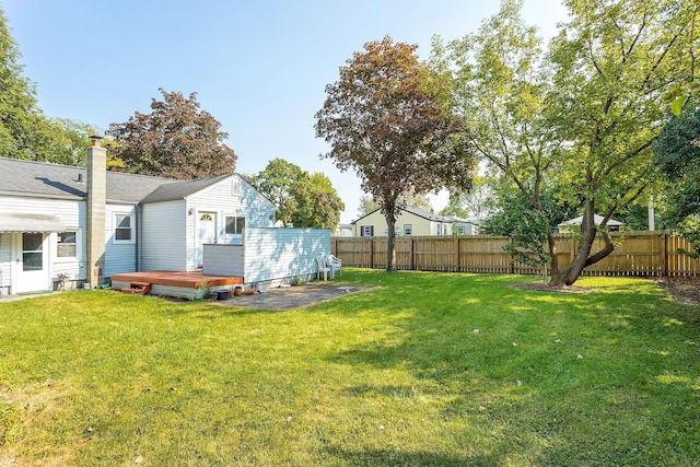 view of yard featuring a fenced backyard and a deck