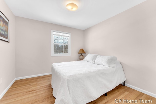 bedroom featuring wood finished floors and baseboards