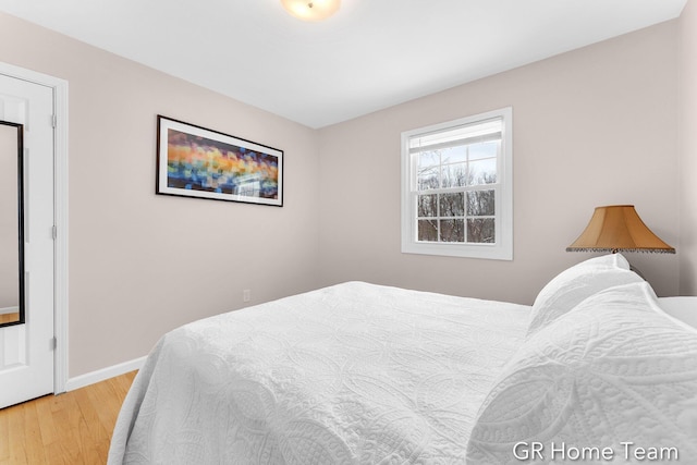 bedroom featuring baseboards and wood finished floors